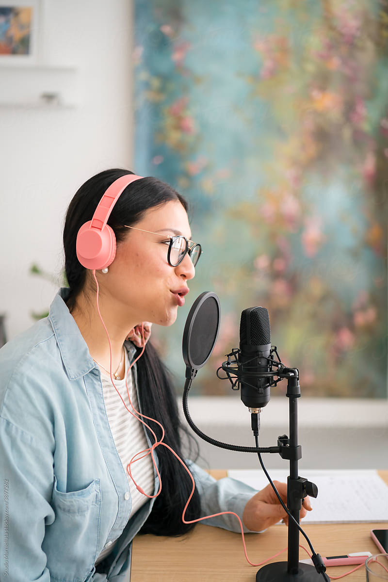Woman recording podcast in modern studio