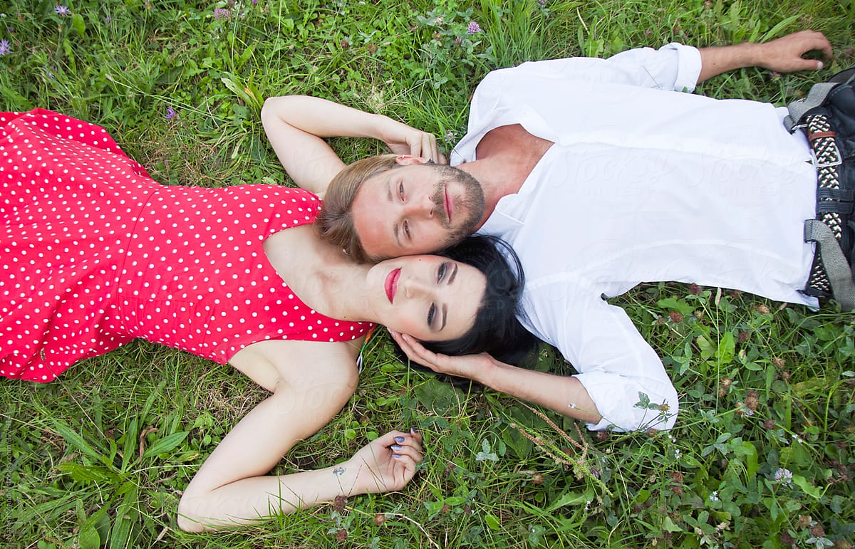 Romantic Couple Laying On The Grass By Nataša Mandić