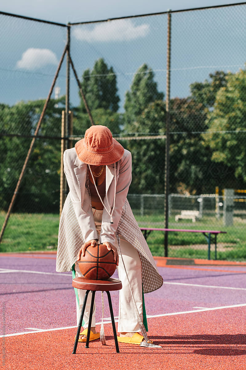 Anonymous Fashionable Young Woman Posing in Streetwear on Basket