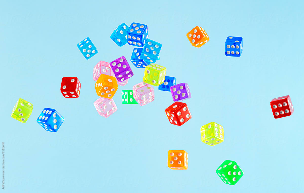 Dice in Air Against Blue Background