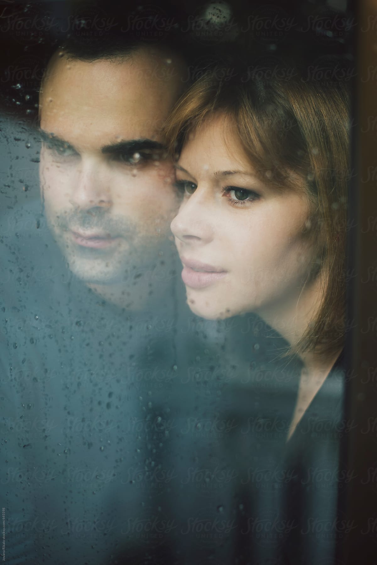 Young couple standing at the window