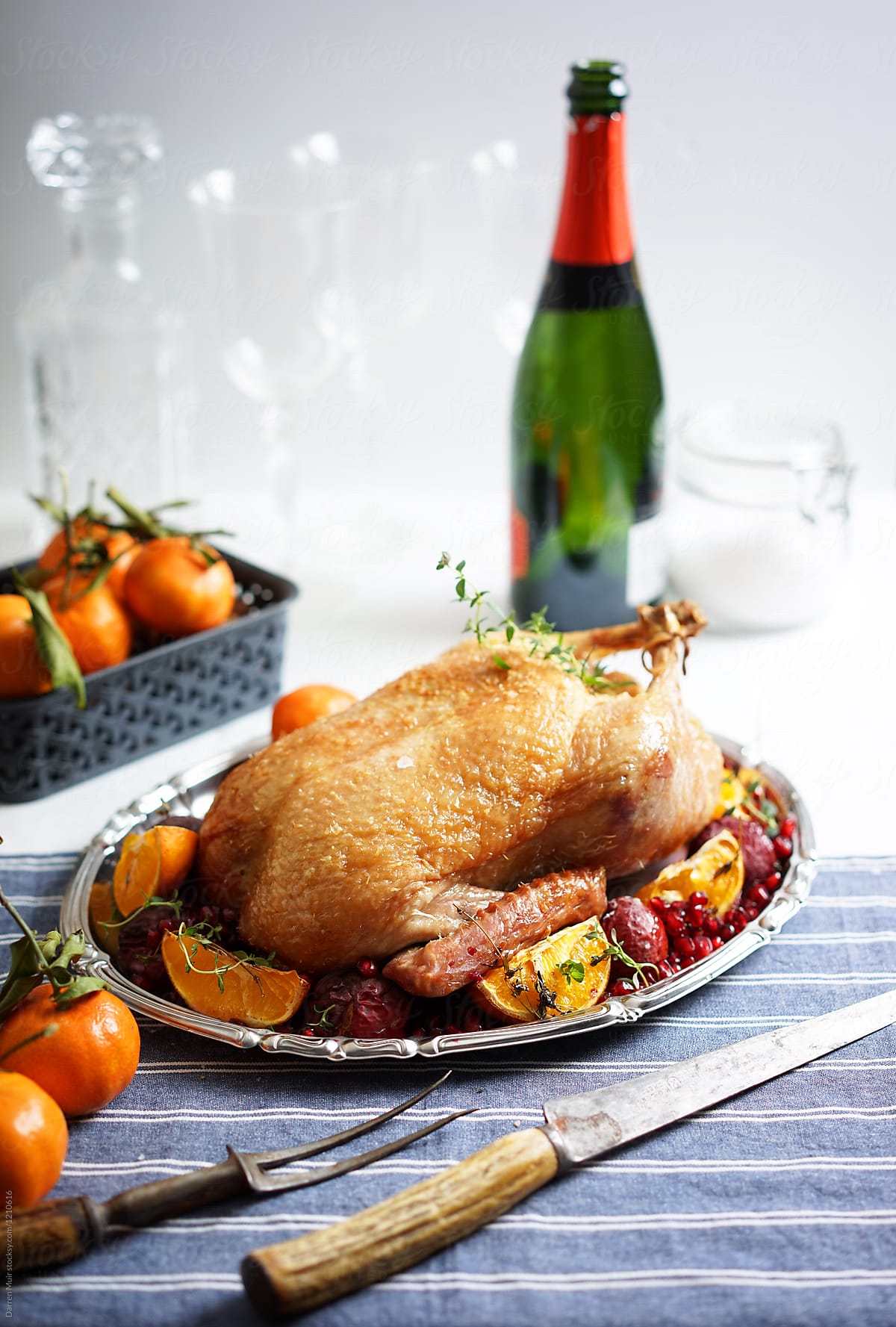 Roast duck with fruits on a salver on a table.