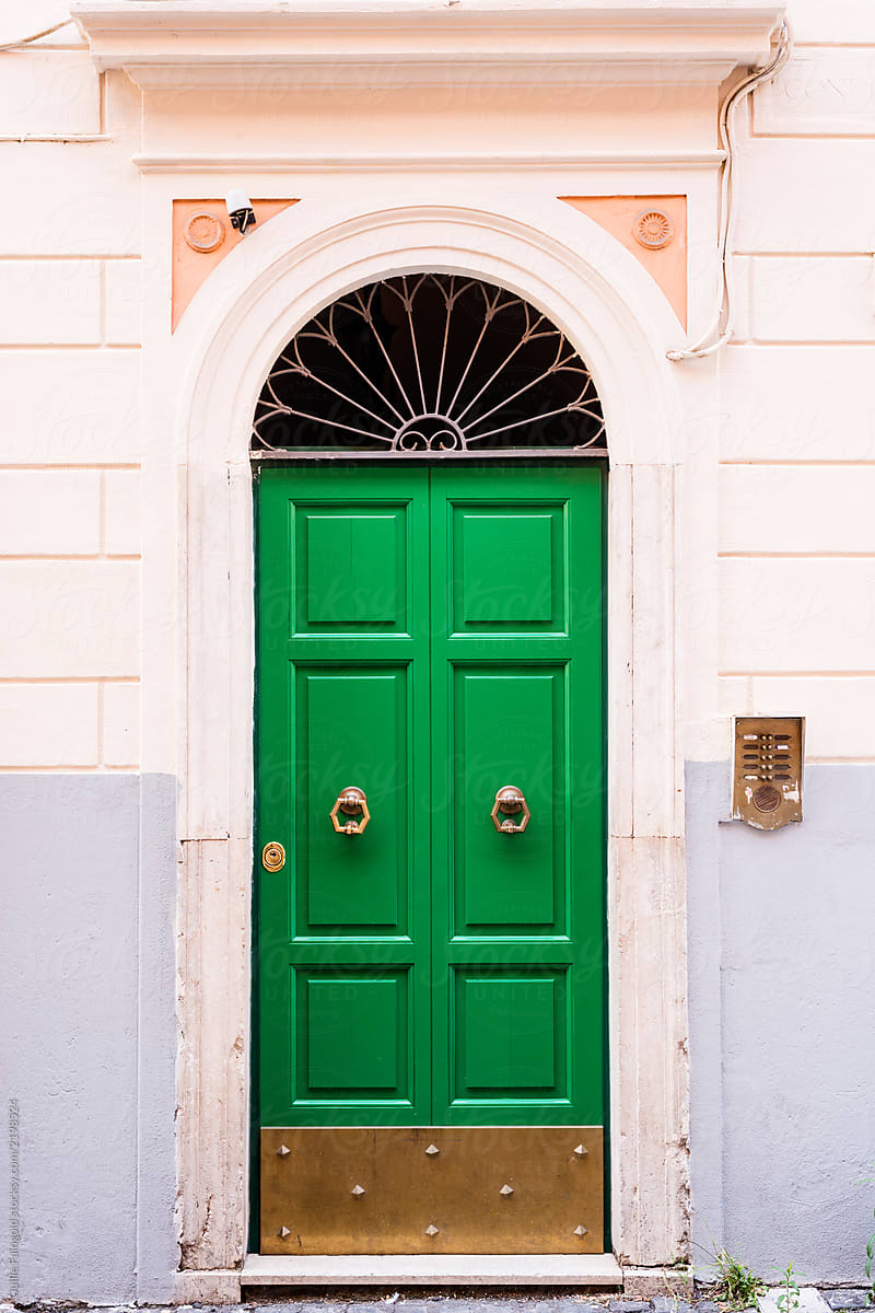 Green doors with golden door knockers.