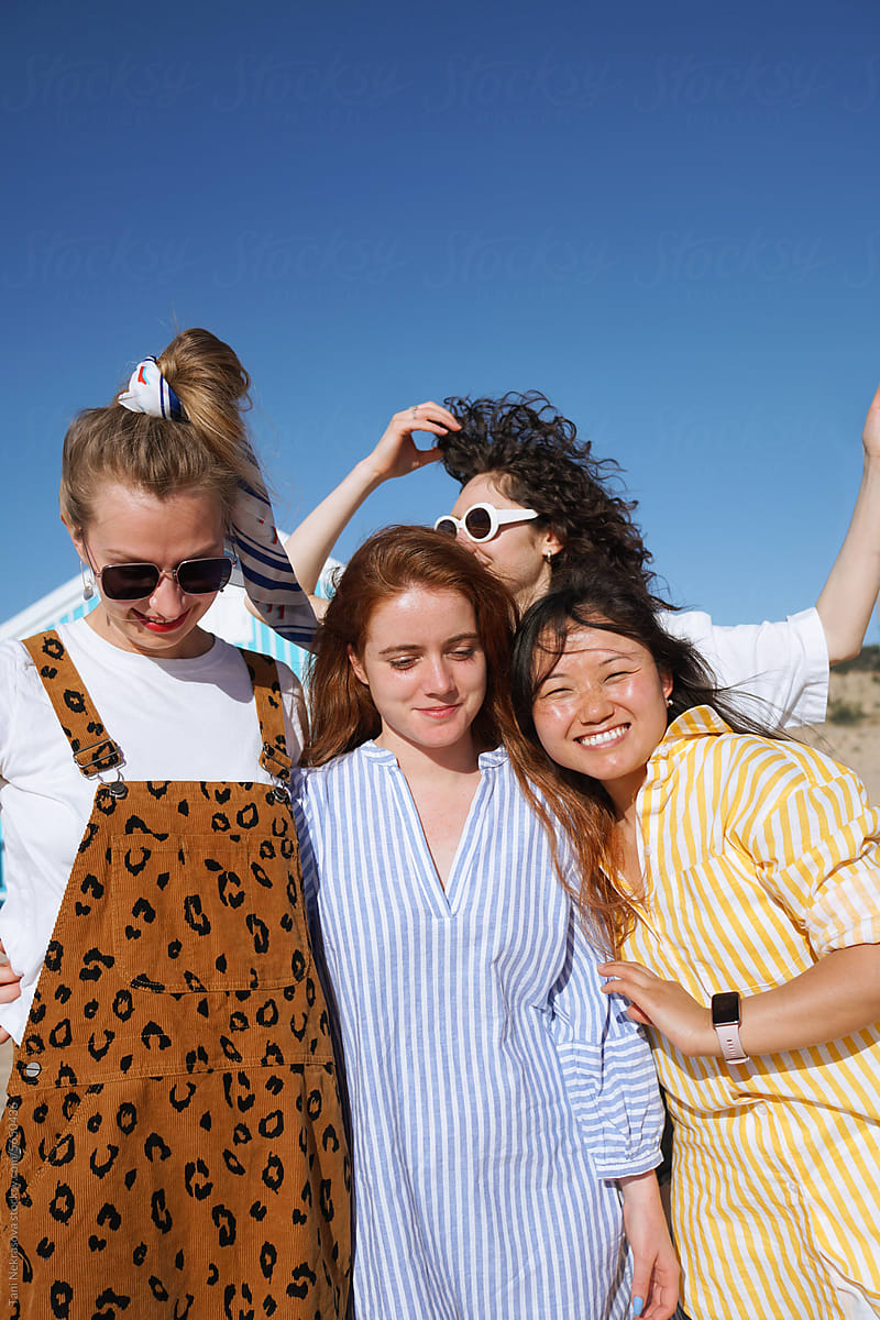 Four young female friends traveling together by the ocean. Friendship
