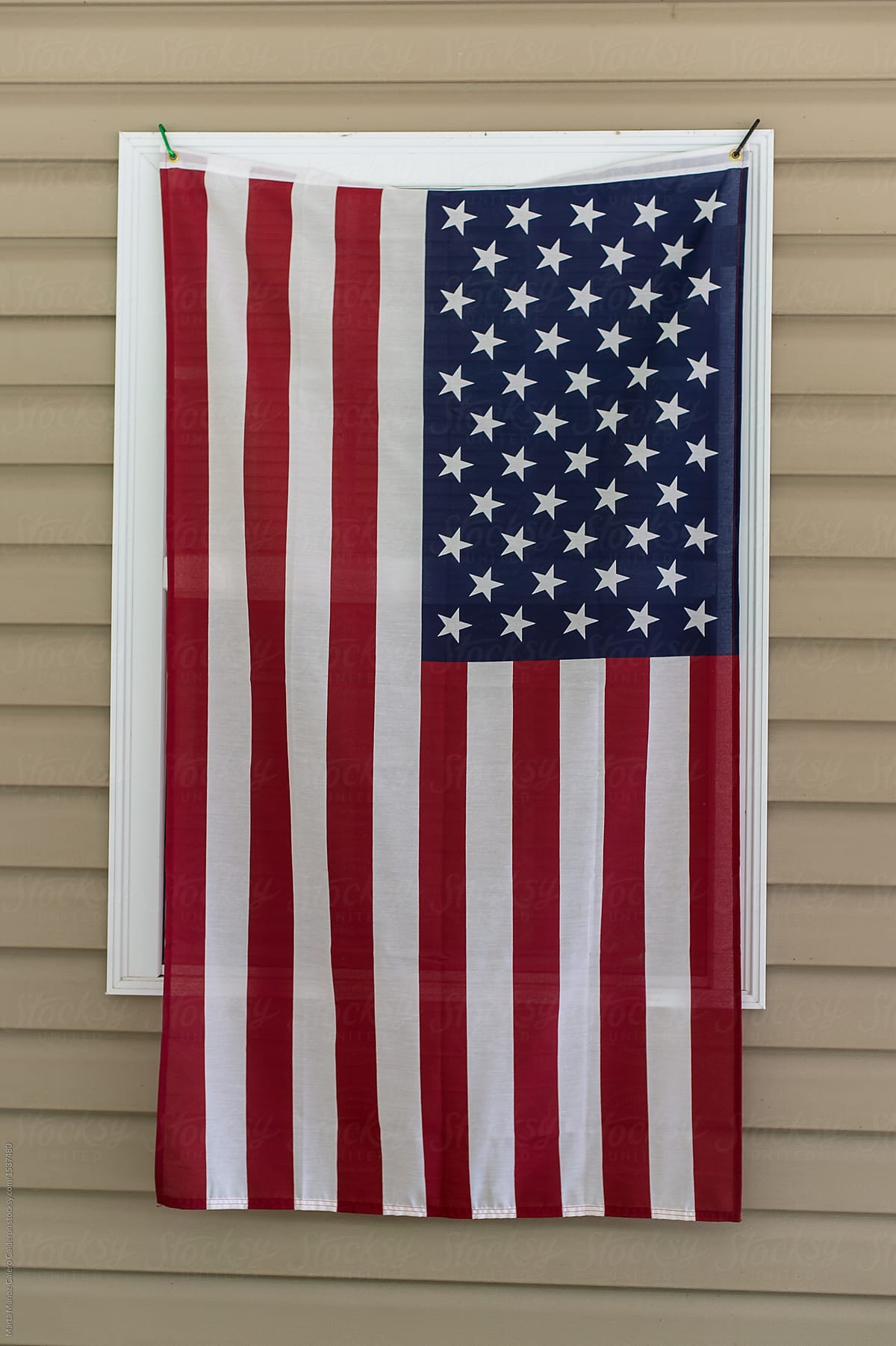 American flag hanging on a window