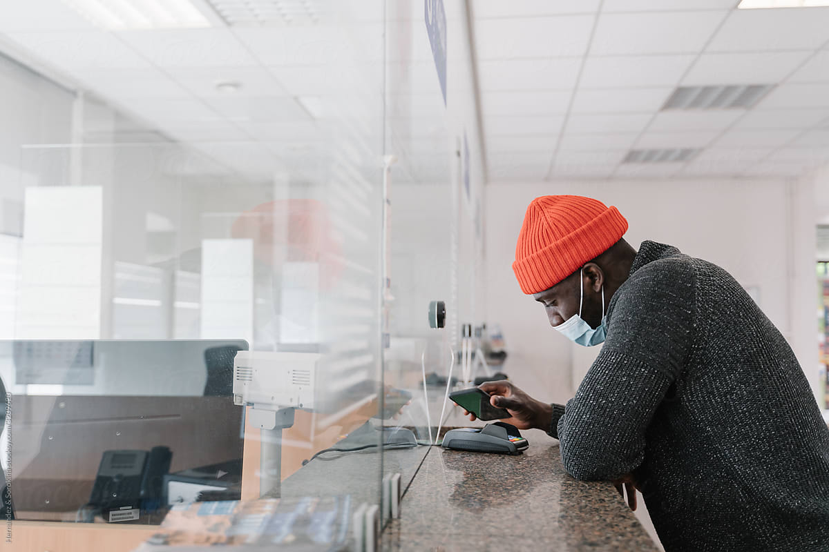 Black Man Wearing Face Mask Using Smartphone To Pay