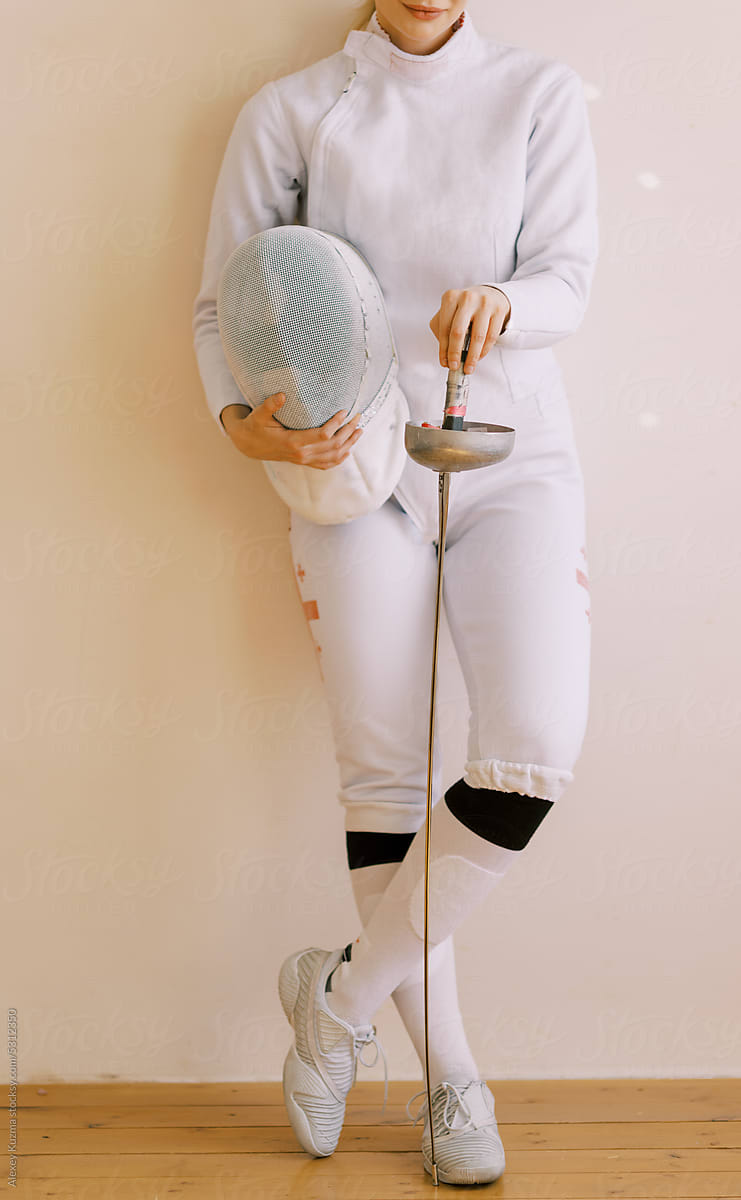 Part of young woman with fencing uniform .