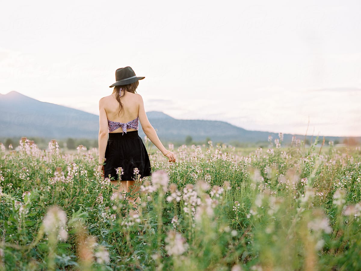 Girl walking in flower field