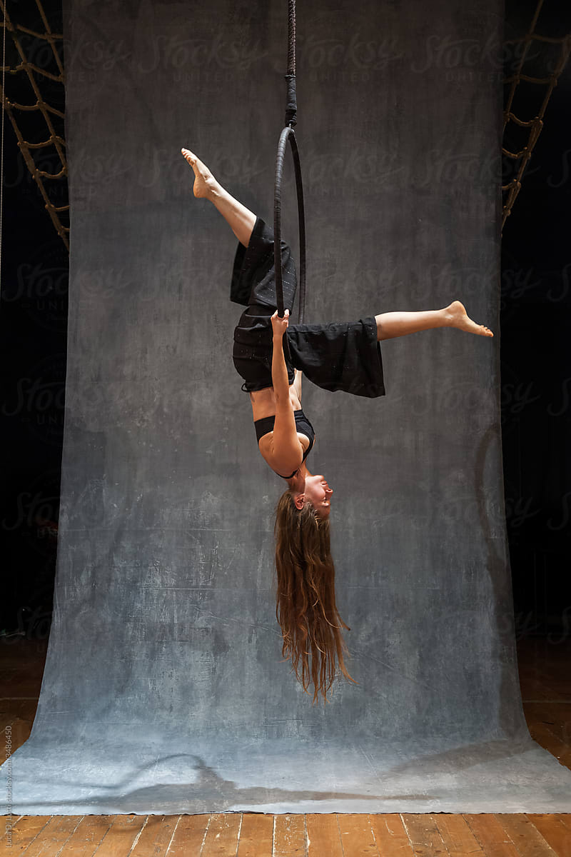 Aerial artist suspended to a Lyra or Aerial hoop 4
