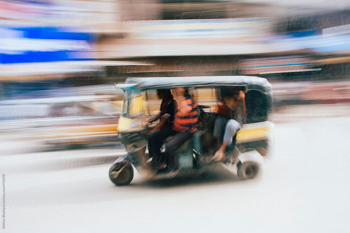 Abstract pan shot of a auto rickshaw in the Indian street.