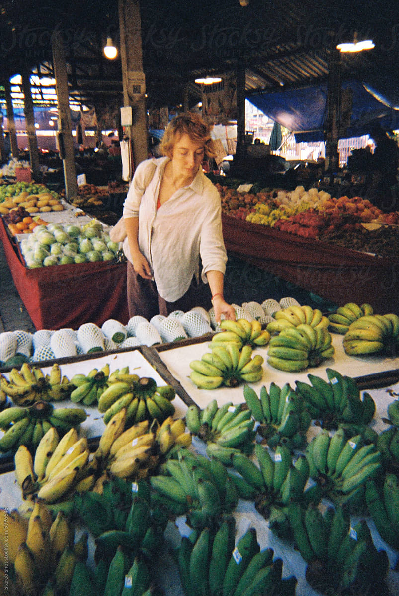 Film photo of Woman with reusable bag buying fruits at local market