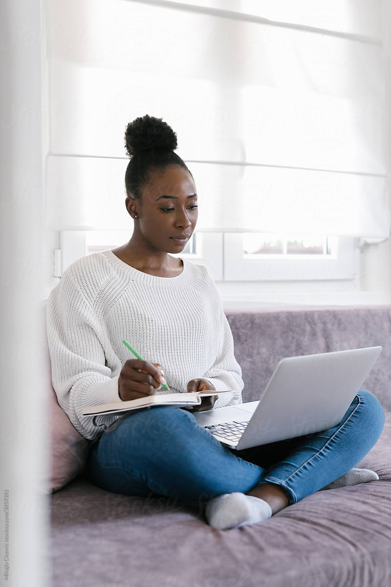 Young black woman studying at home