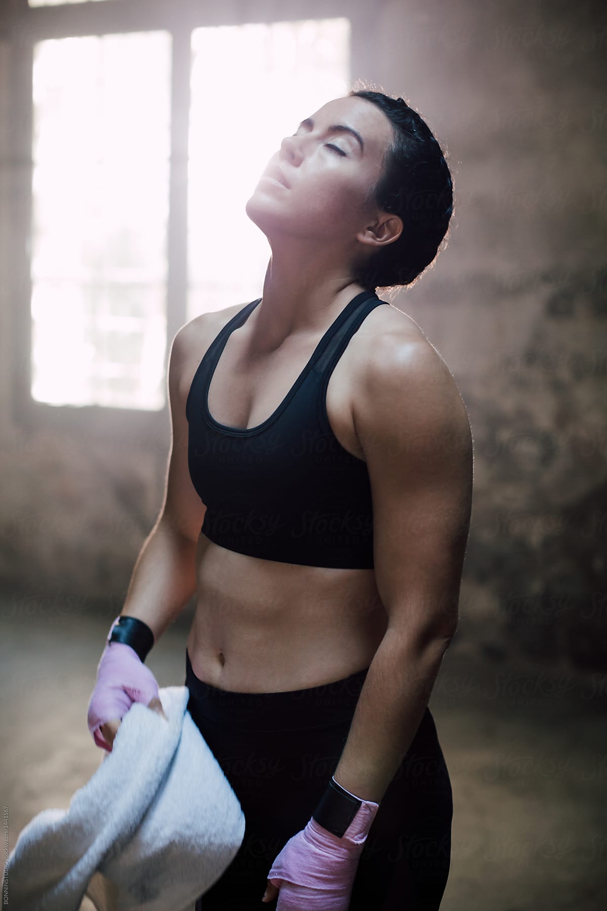 Woman Putting On Her Sport Bra Before Exercise by Stocksy Contributor  Take A Pix Media - Stocksy