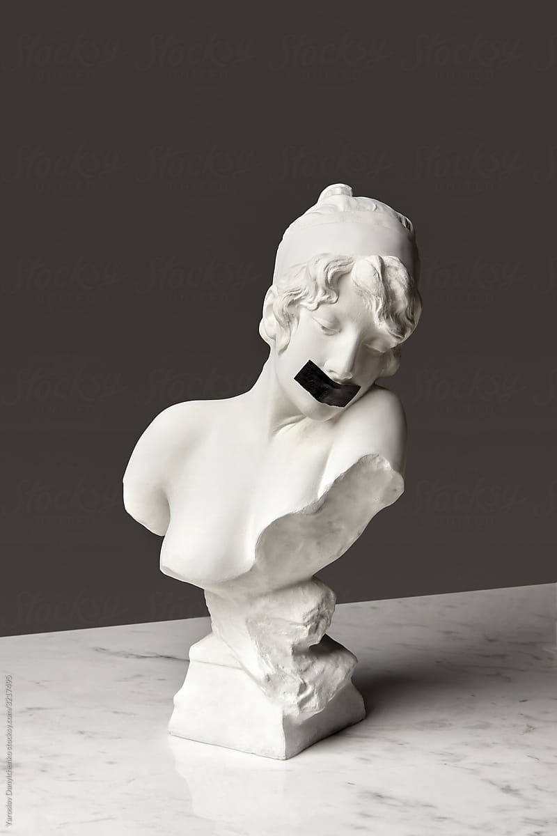 Gypsum statue with taped mouth.