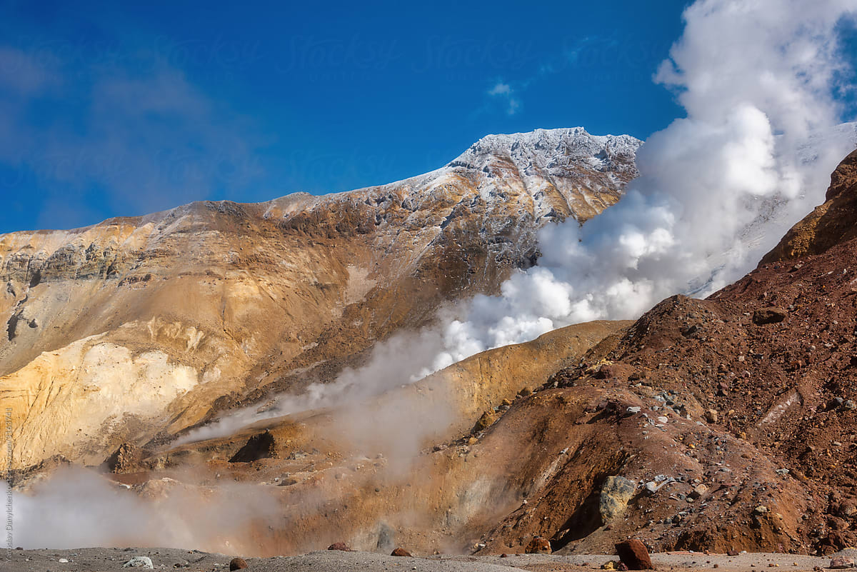 Rock volcanic landscape with smoking fumaroles.