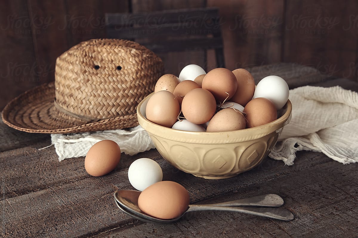 Bowl of fresh country eggs on rustic table