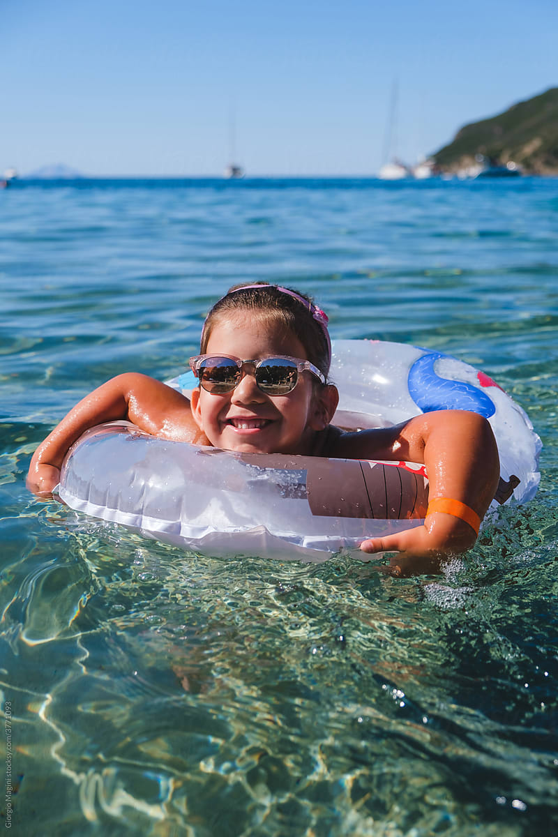 Litle Girl with Inflatable Donut in the Sea