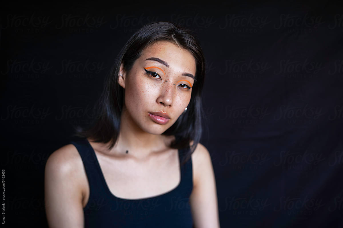 Young woman with makeup and ear piercing