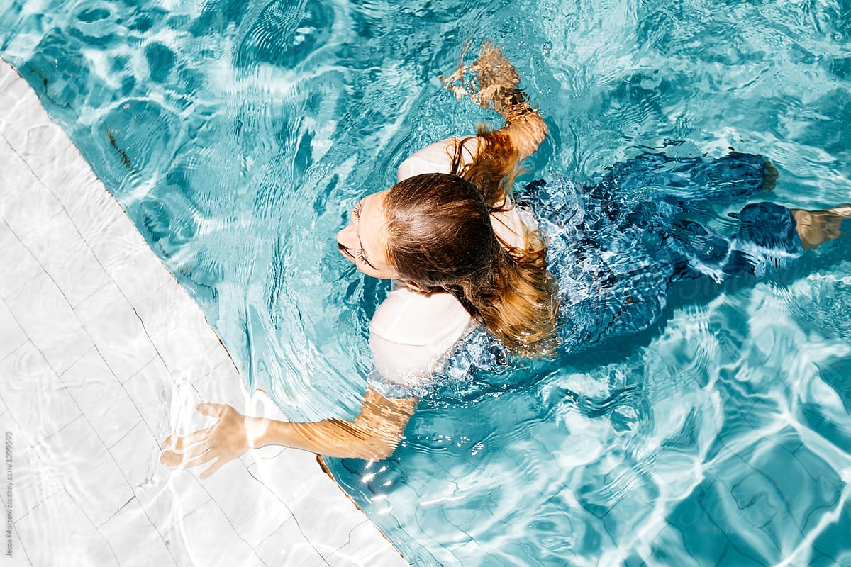 Young Woman Wearing All Her Clothes While Swimming In Pool During Night Time Spontaneous Summer 