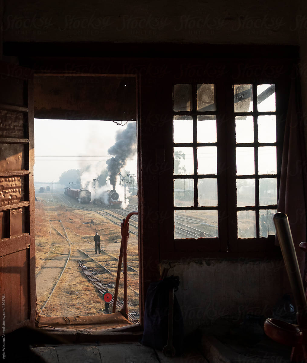 A Steam Train framed through the window of a signal cabin