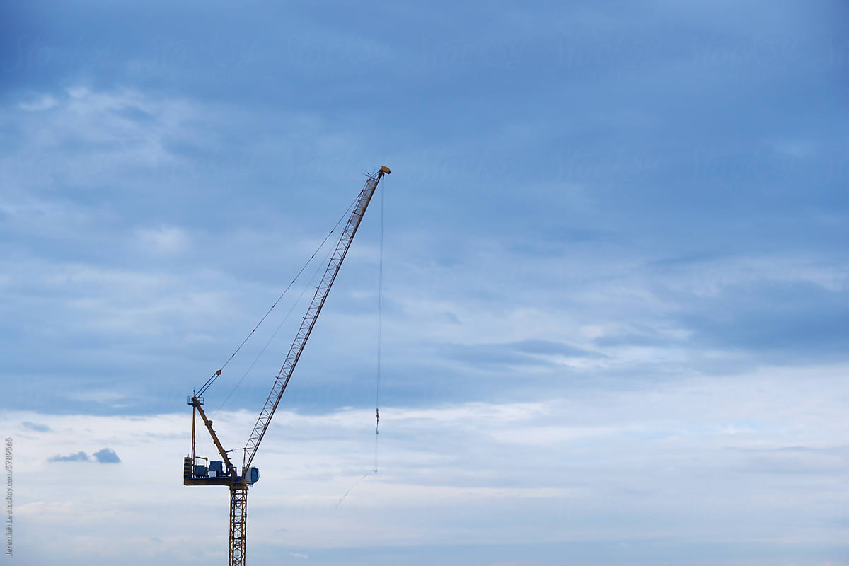 The constraction crane under the blue sky