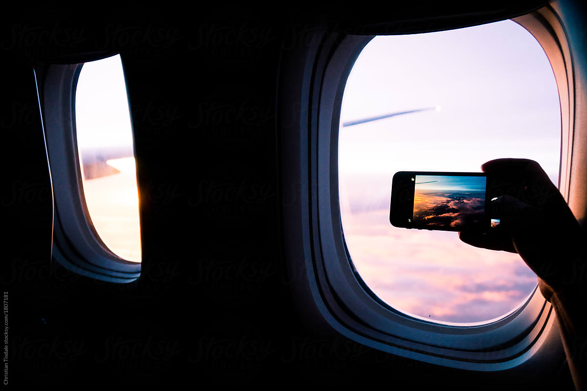 Taking a cellphone picture out the window of an airplane