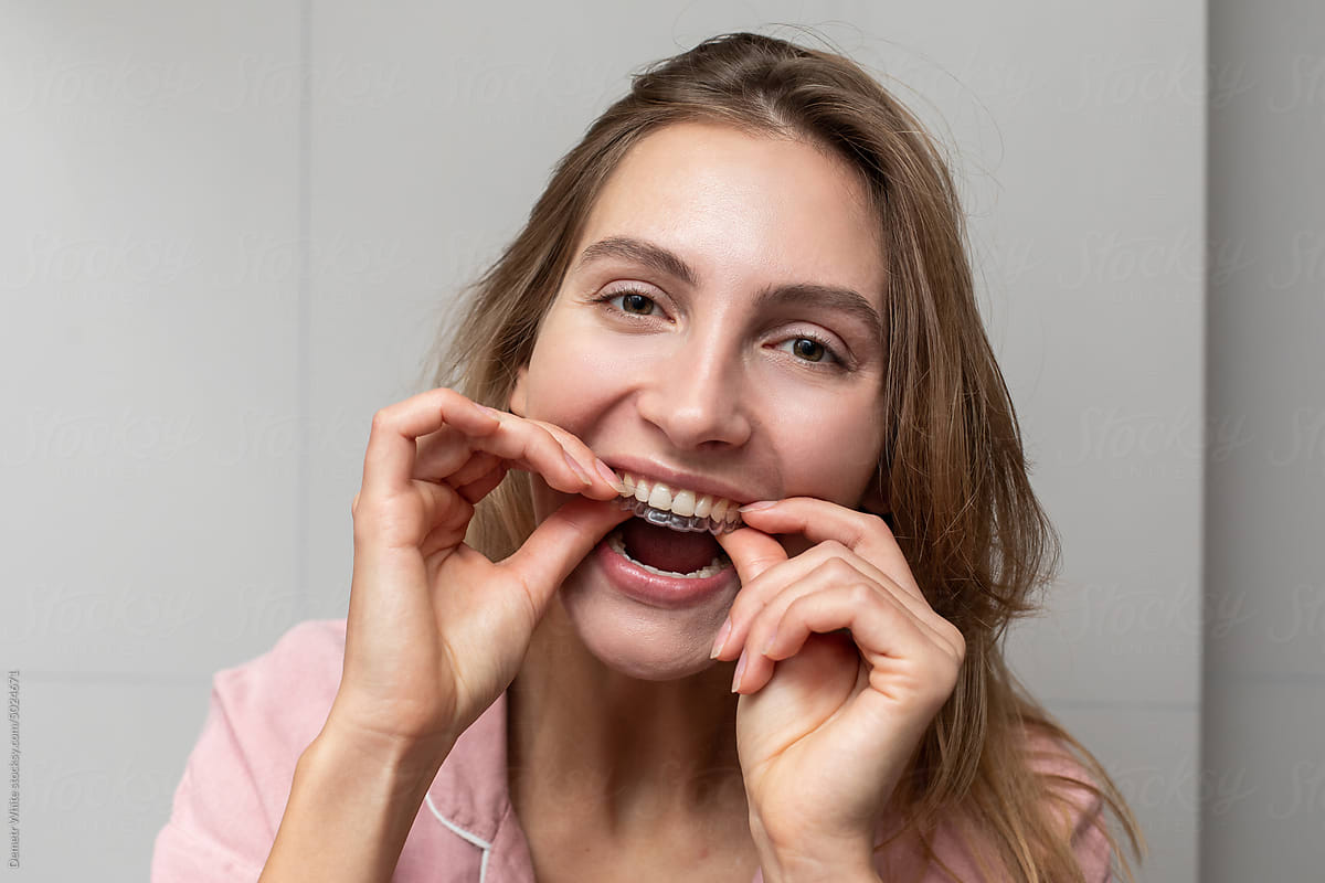 Woman puts dental retainer out