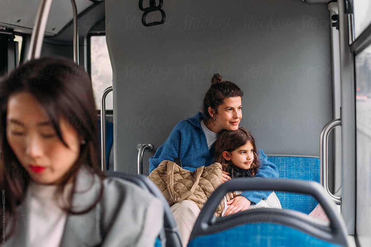 Mom and daughter riding bus