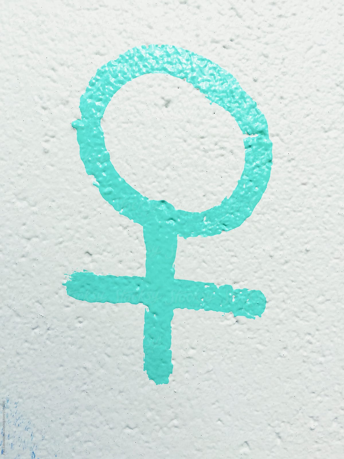 Painted female symbol on building wall, close up