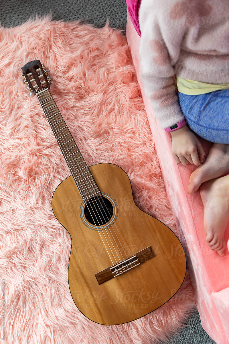 Furry Pink rug with acoustic guitar still life with feet