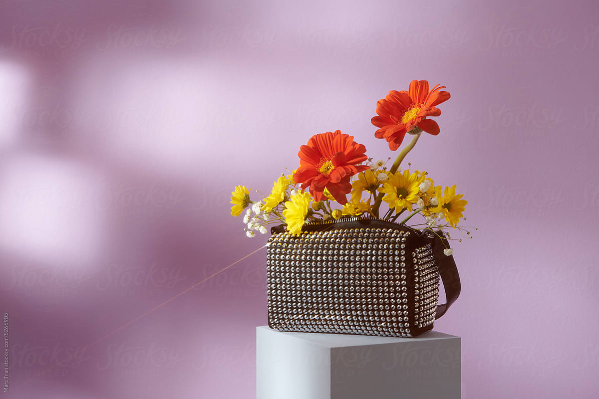 Bouquet of colorful gerbera in a sparkly women's bag
