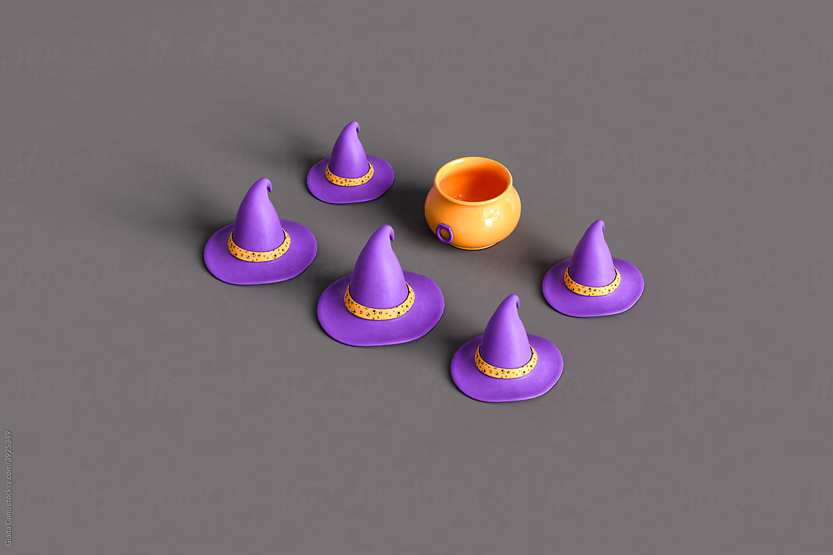 purple witch hats and orange cauldron on dark grey background