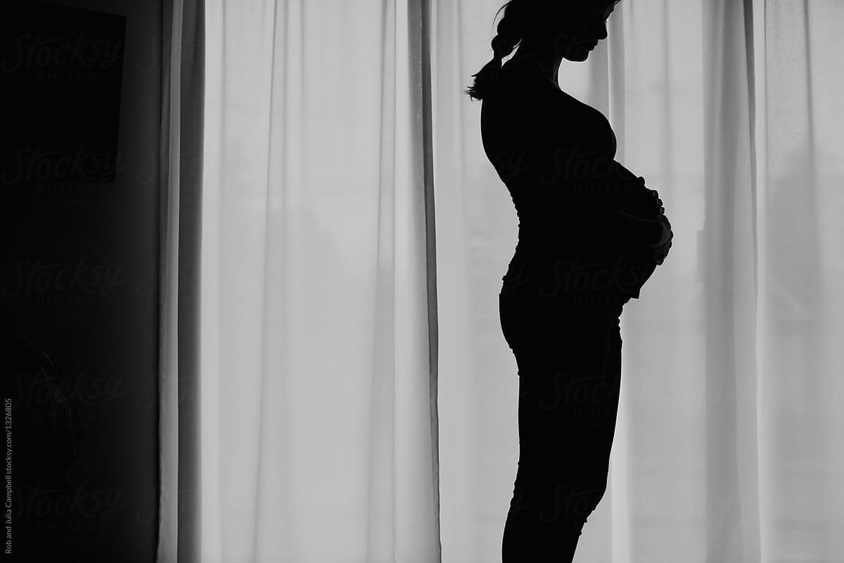 Content pregnant woman at home - silhouette in black and white