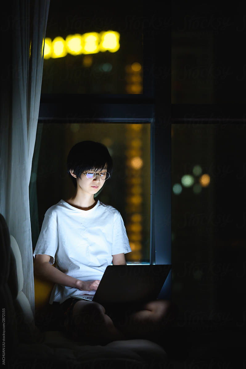 young woman working from home at night