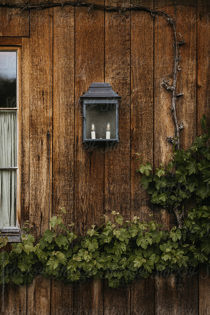 Rustic lantern on weathered wooden cabin wall