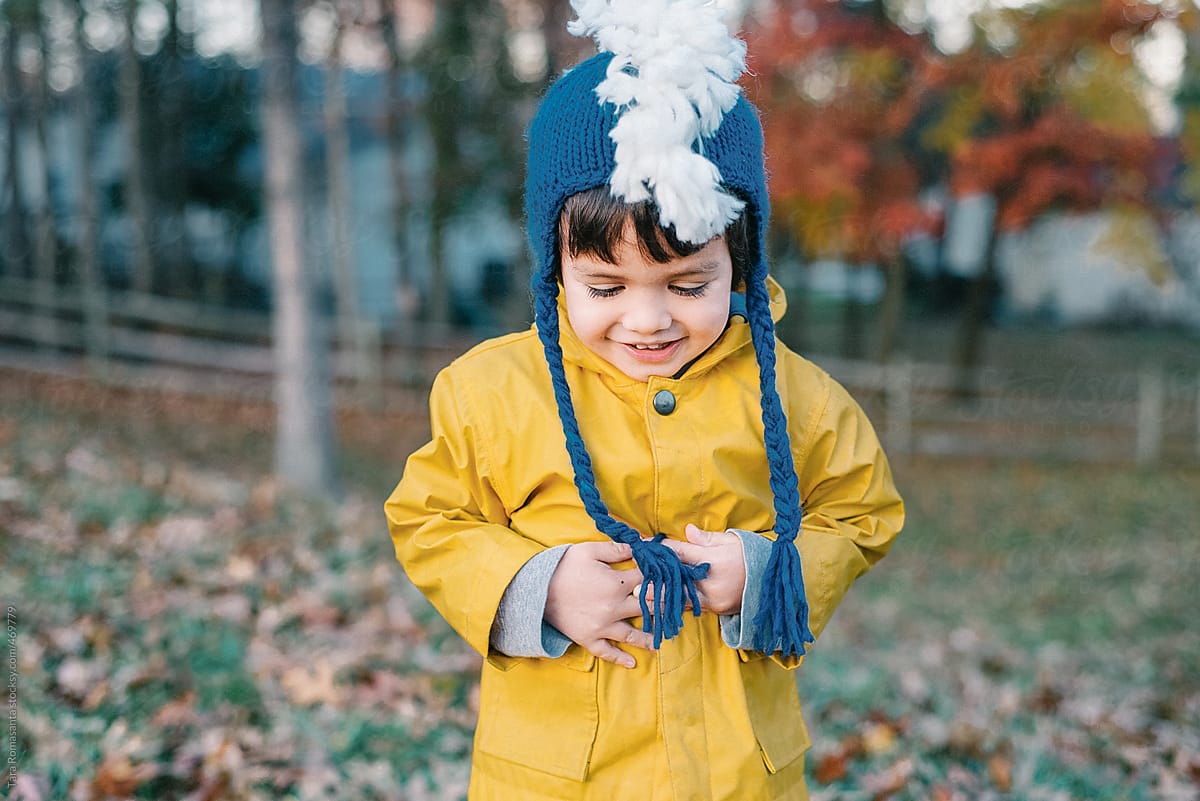 boy in a silly hat happy to be outside in autumn