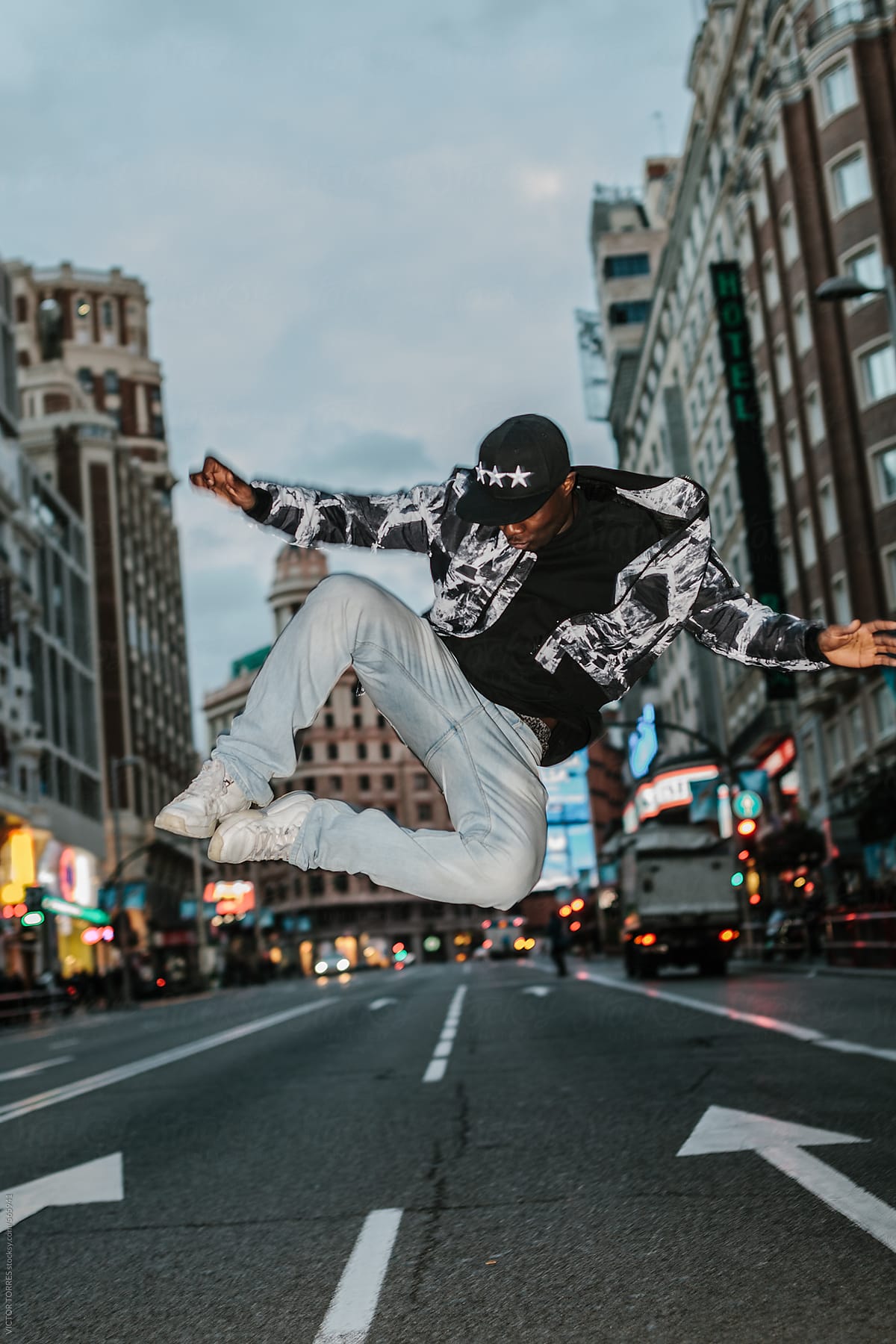 Black Man Jumping in the Middle of an Urban Road