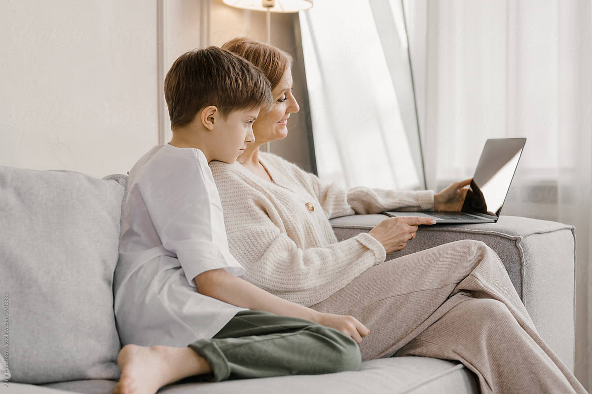 Mother and son watching movie on laptop