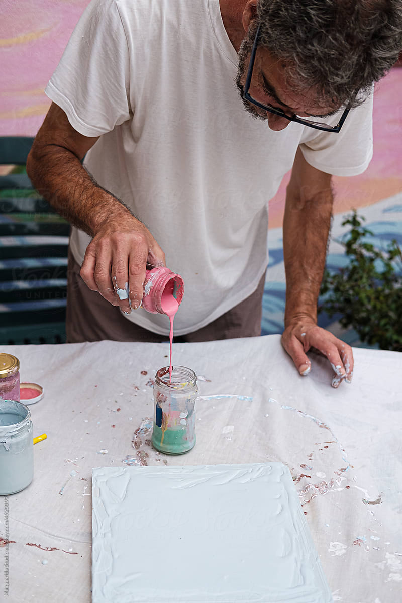 Artist man mixing paint for painting