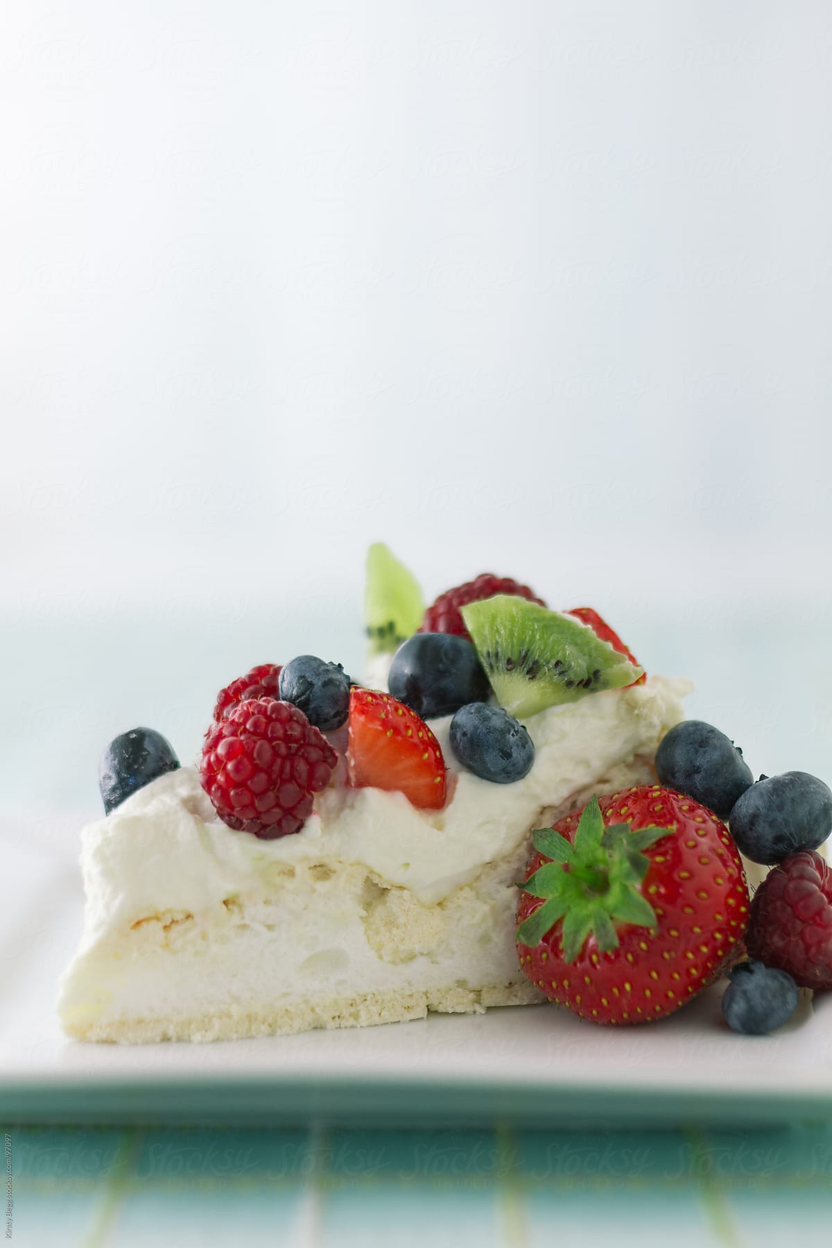 Pavlova slice with summer berries vertical