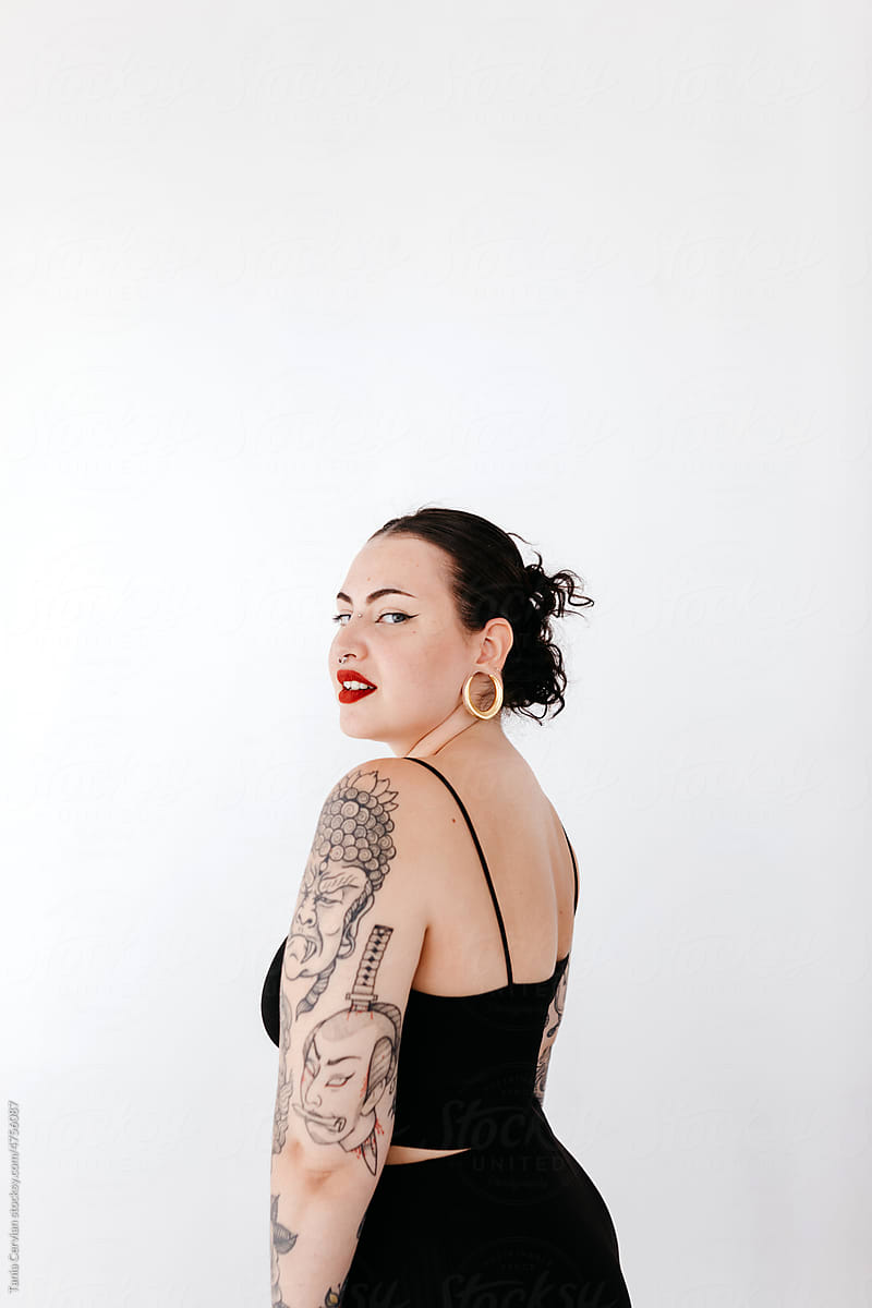 Attractive woman with tattoos on arm