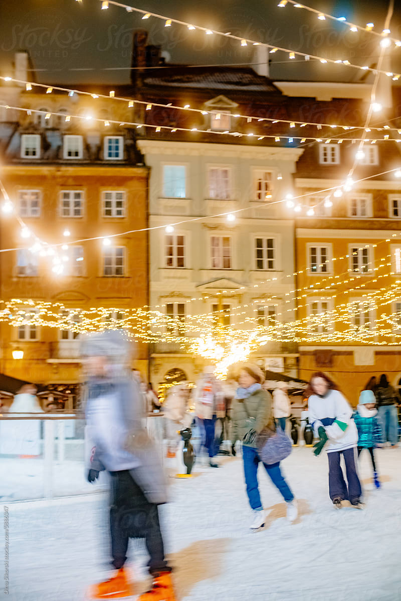 Outdoor Ice rink with many tourists in the old European city