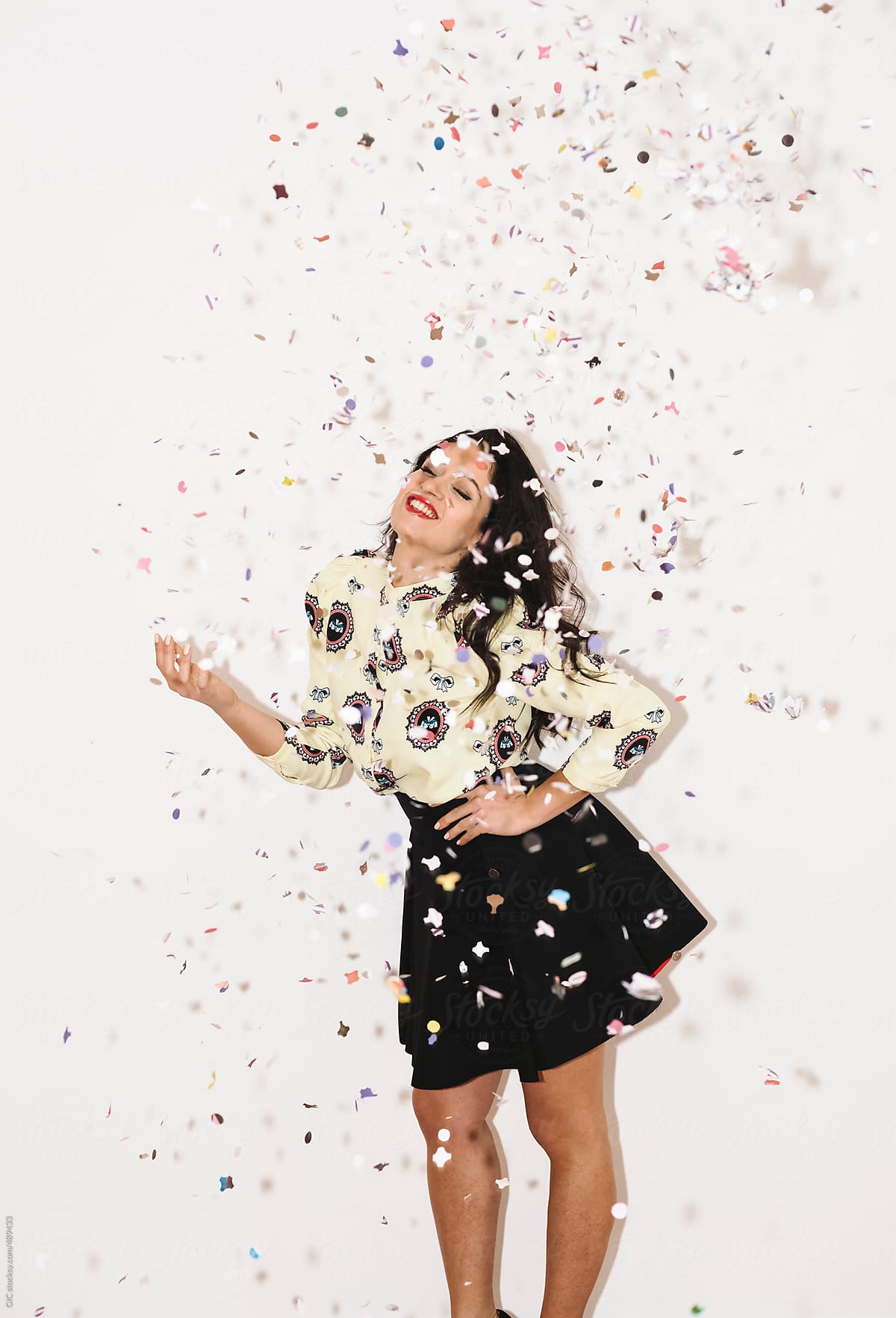 Woman enjoying the party with confetti in air