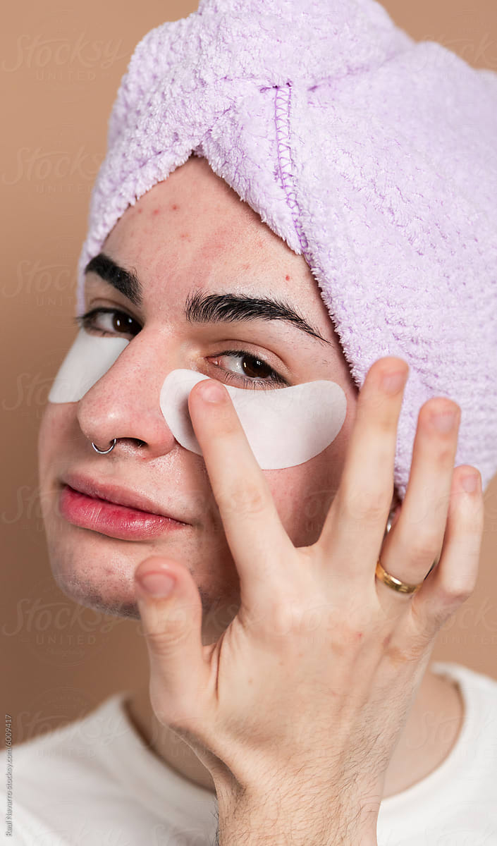 Man applying facial skincare treatment