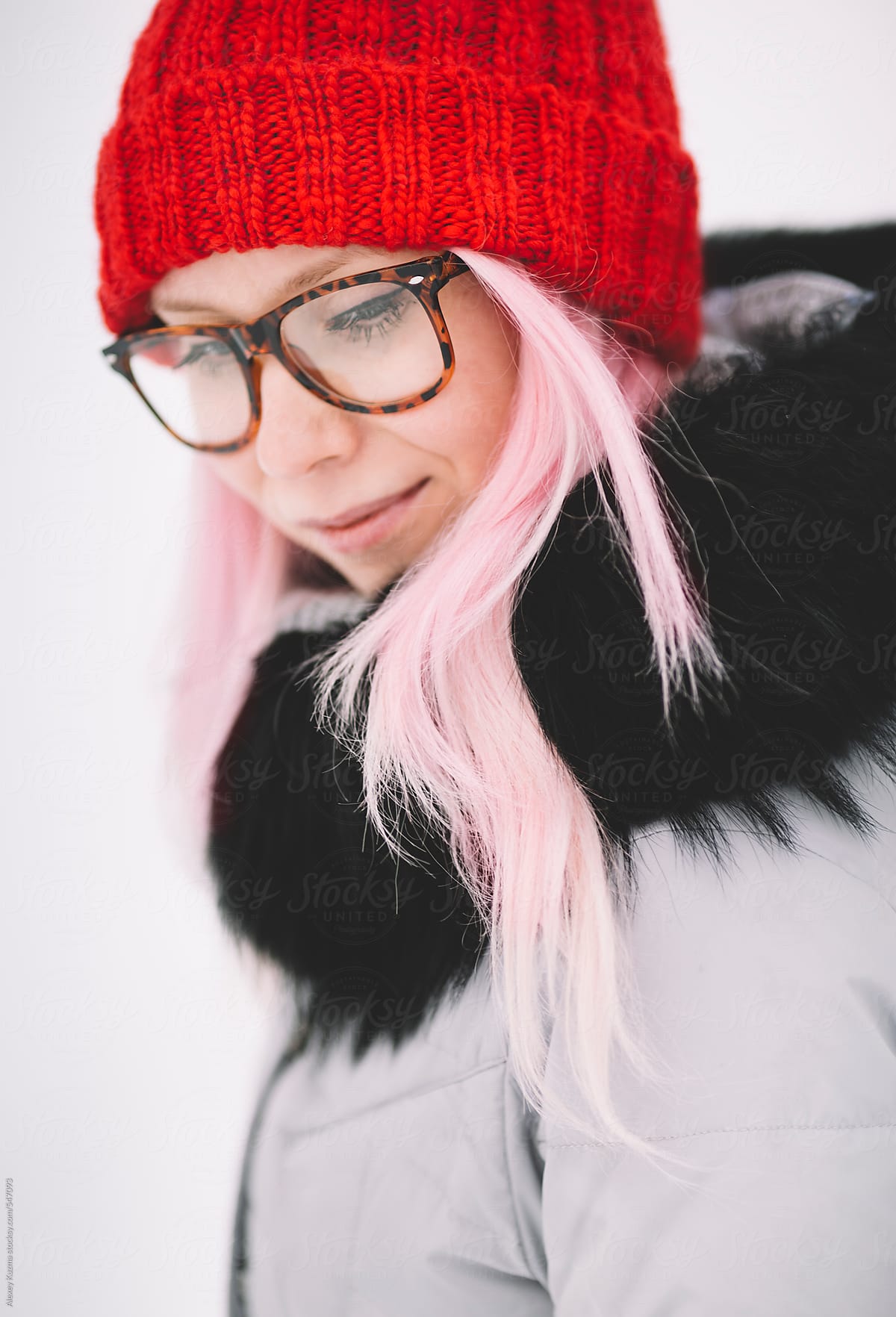 woman with pink hair and red hat.