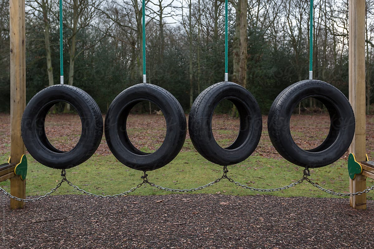 Group of tyres (tires) used as a swing in a children\'s outdoor play area