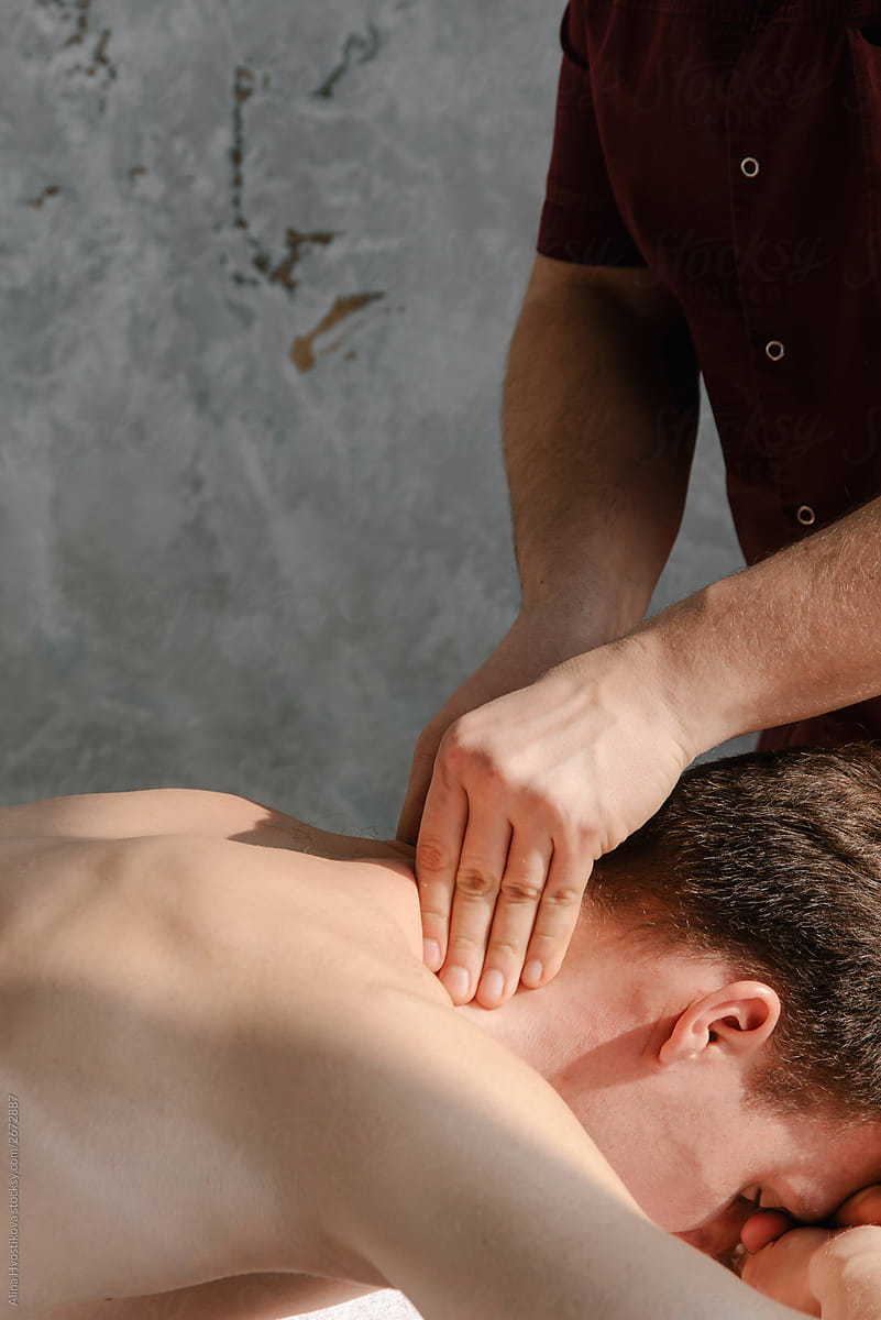 Male lying on table and relaxing of massage session.