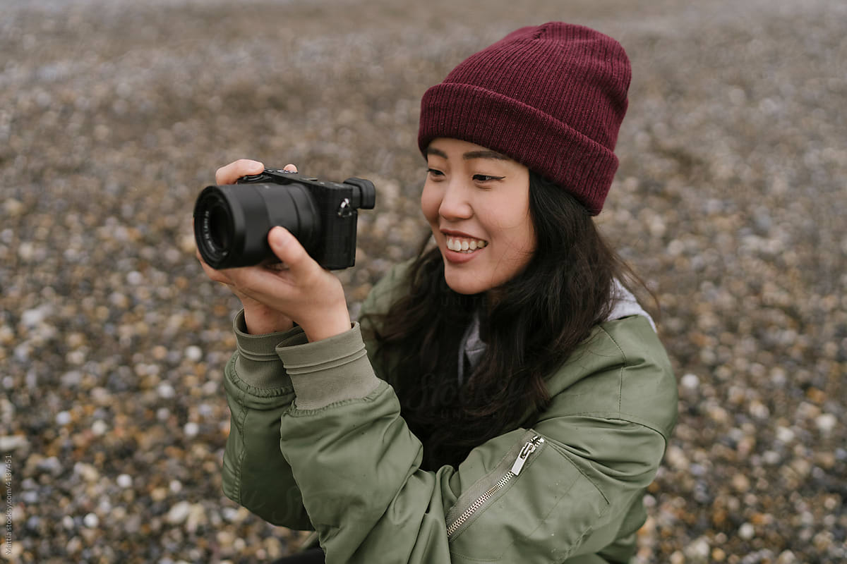 Young Asian Female Photographer on the Beach