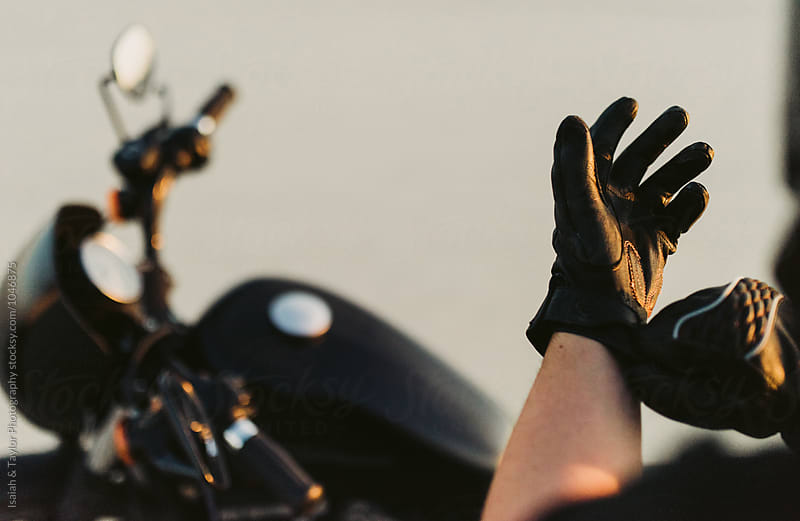 Motorcyclist putting on gloves