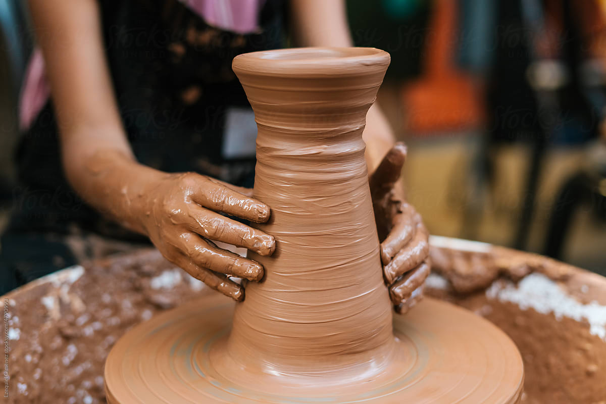 Anonymous person making clay vase